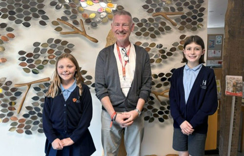 Two ten year old girls visited St Helena Hospice to write an article for the newspaper, here they are pictured with fundraiser James