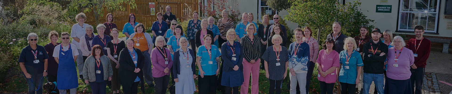 St Helena staff and volunteers standing in front of the hospice