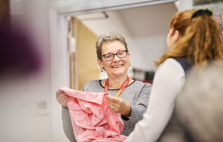 A St Helena volunteer holding a shirt